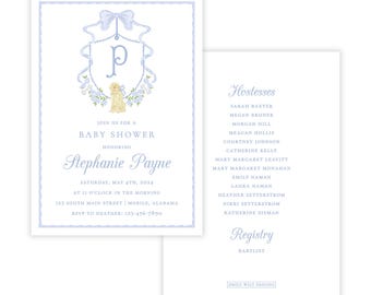 May include: A blue and white baby shower invitation with a monogrammed crest featuring a puppy and a bow. The invitation includes the text "Join us for a Baby Shower Honoring Stephanie Payne" and details about the event. The back of the invitation lists the hostesses and registry information.