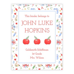 May include: A personalized binder with a white background and a blue border. The binder features the name "JOHN LUKE HOPKINS" in red, along with three red apple illustrations. The binder also includes the text "Goldsmith-Schiffman, 1st Grade, Mrs. Wilson."