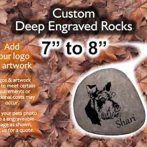 May include: A custom engraved rock with a black and white image of a dog and the name "Shari" engraved on it. The rock is 7 to 8 inches in diameter and is surrounded by brown leaves. The text "Custom Deep Engraved Rocks" is at the top of the image.