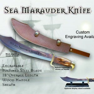 May include: A "Sea Marauder Knife" with a polished steel blade, wood handle, and leather sheath. The blade has black engraving that reads "Not All Treasure Is Silver & Gold." The knife is 18 inches in overall length. Custom engraving is available.