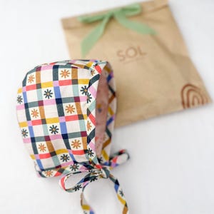Bonnet laid beside kraft paper packaging