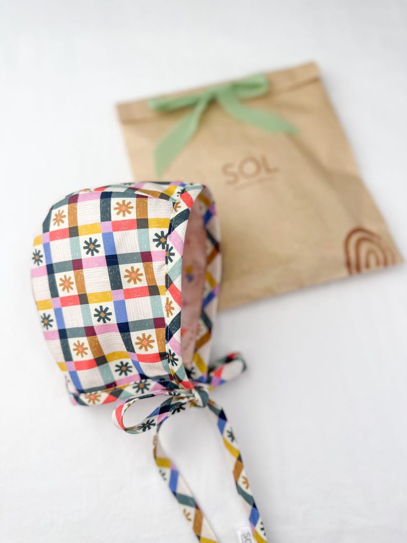 Bonnet laid beside kraft paper packaging