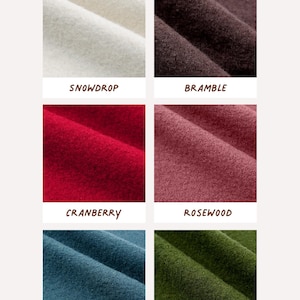 May include: A grid of six fabric swatches labeled AVAILABLE IN 6 COLOURS, featuring colors Snowdrop, Bramble, Cranberry, Rosewood, Juniper, and Olive. Each swatch displays a textured, folded material in distinct shades of white, dark brown, red, dusty rose, blue, and green.