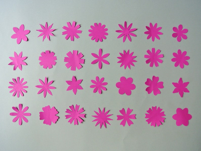 May include: Thirty-six pink paper flowers of various sizes and shapes, arranged in four rows of nine flowers each.