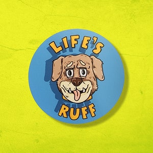 May include: A blue and yellow round sticker with a cartoon dog's face and the text "LIFE'S RUFF"