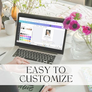 May include: A person customizing a digital design on a laptop computer. The design features a photo of a woman and the text "Save Your Money". The laptop is on a white desk with a vase of pink flowers.