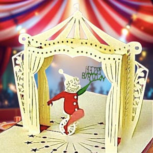 Tarjeta de cumpleanos pop-up Circo – Payaso en monociclo bajo carpa 3D