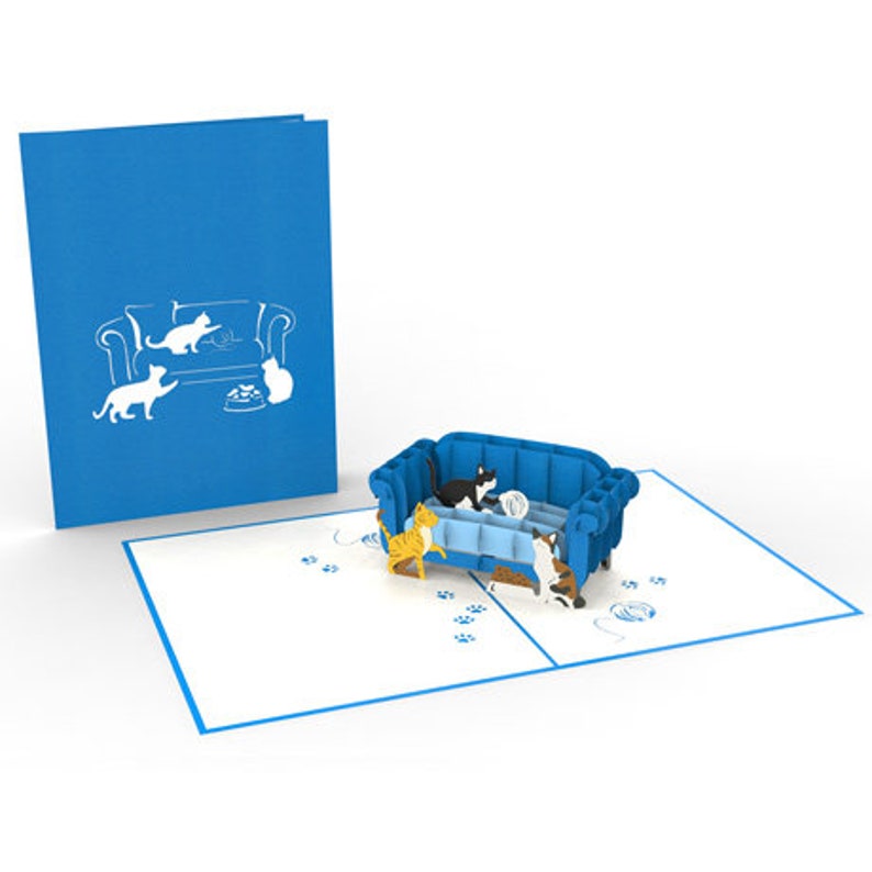 Cat Trouble pop up card: 3 playful cats cavort by a blue couch. They are ready to create mischief.