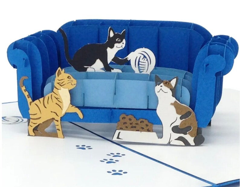 Cat Trouble pop up card: 3 playful cats cavort by a blue couch. They are ready to create mischief.