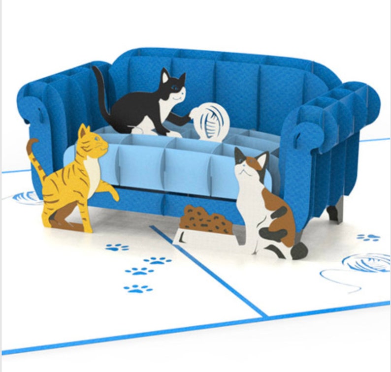 Cat Trouble pop up card: 3 playful cats cavort by a blue couch. They are ready to create mischief.