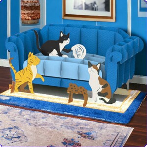 Cat Trouble! Pop up card: 3 playful cats cavort by a blue couch. They art ready to create mischief.