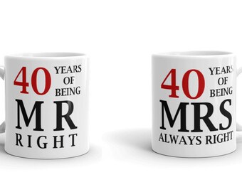 May include: Two white ceramic mugs with black text and red numbers. The mug on the left says "40 Years of Being Mr Right". The mug on the right says "40 Years of Being Mrs Always Right".