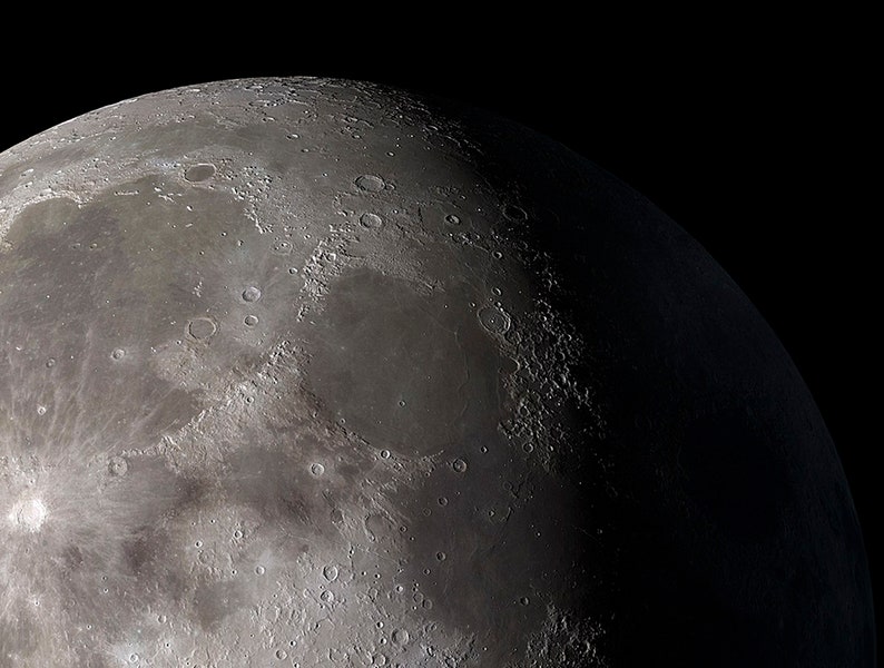 May include: A close-up view of the moon's surface, showing craters and other geological features. The moon is a celestial body that orbits the Earth.