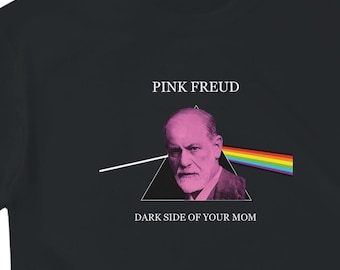 May include: Black t-shirt featuring a graphic with the text "PINK FREUD" above an image of Sigmund Freud and a rainbow prism. The text "DARK SIDE OF YOUR MOM" is below the image.