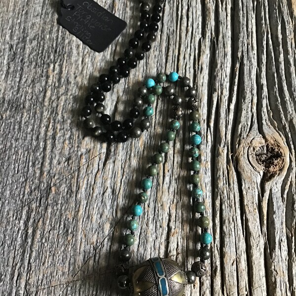 Turquoise, pyrite, obsidian necklace assembled with sterling silver pendant.