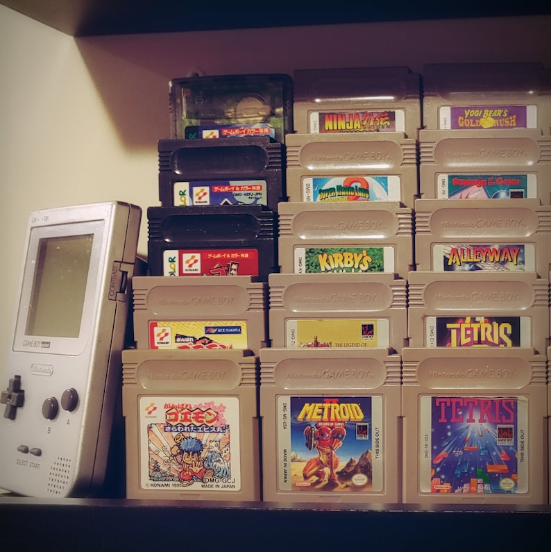 May include: A collection of vintage Game Boy cartridges, including titles like "Ninja Gaiden", "Yogi Bear's Gold Rush", "Tetris", "Metroid", and "Kirby's Dream Land".