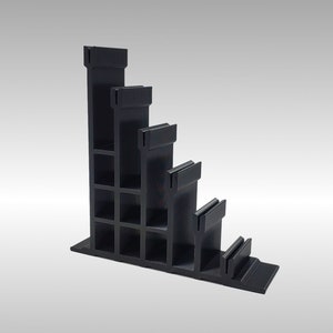 May include: Black plastic shelf unit with five tiers, each tier is slightly smaller than the one above it. The shelf unit is angled and has a rectangular base.