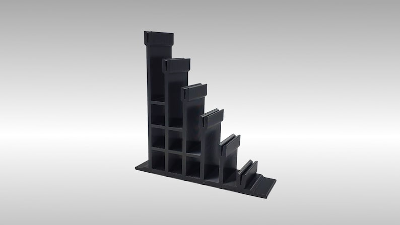 May include: Black plastic shelf unit with five tiers, each tier is slightly smaller than the one above it. The shelf unit is angled and has a rectangular base.