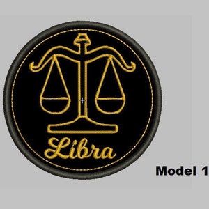 May include: Black and gold embroidered patch featuring the Libra zodiac symbol and the word "Libra" in a cursive font.
