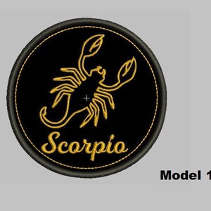 May include: Black and gold embroidered patch with a scorpion design and the word "Scorpio" in a script font.