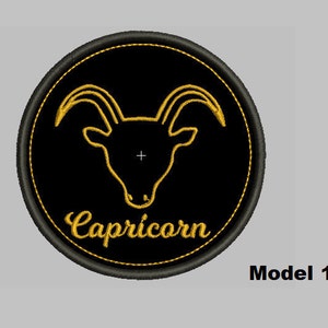 May include: Black and gold embroidered patch with a stylized image of a goat's head and the word "Capricorn" in a script font.