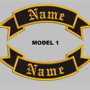 May include: Two black and gold embroidered patches with a banner design. The banner reads "Name" in a gothic font. The text "MODEL 1" is printed below the patches.