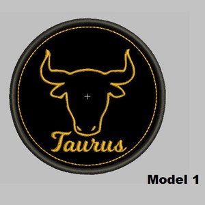 May include: Black and gold embroidered patch with a bull silhouette and the word "Taurus" in a script font.
