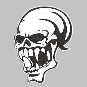 May include: Black and white embroidered patch of a skull with a large open mouth and a long tongue. The skull has a stylized design with a pointed top and a curved line on the side.