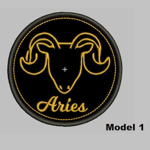 May include: Black and gold embroidered patch with the zodiac symbol for Aries, a ram's head with horns, and the word "Aries" below.
