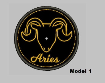 May include: Black and gold embroidered patch with the zodiac symbol for Aries, a ram's head with horns, and the word "Aries" below.