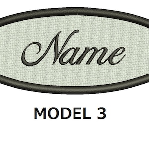 May include: A white oval-shaped patch with a black border and the word "Name" embroidered in black cursive lettering. The text "MODEL 3" is printed below the patch.