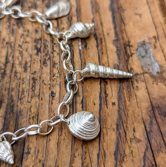 Cornish Silver Sea Shell Charm Bracelet, Handcrafted for Ocean Lovers  featuring 7 charms.
