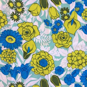 May include: A blue and yellow floral print fabric with a repeating pattern of flowers, leaves, and tulips.
