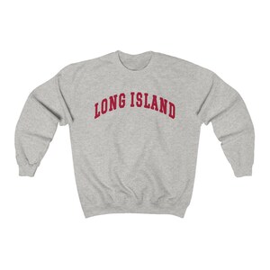 May include: A gray sweatshirt with the text "LONG ISLAND" in red.