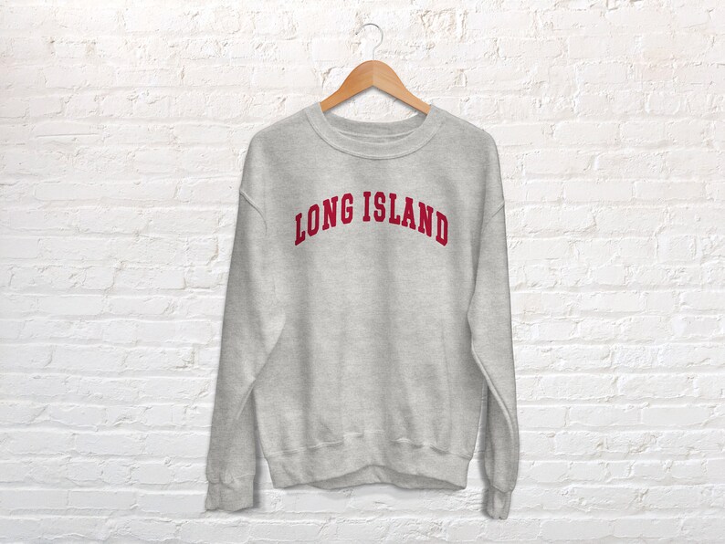 May include: A gray sweatshirt with the text "LONG ISLAND" in red lettering.