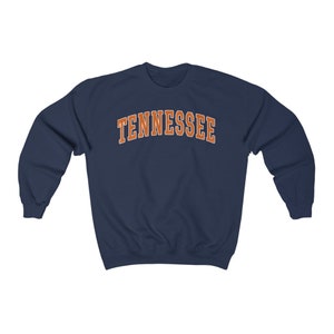 May include: Navy blue sweatshirt with the word "TENNESSEE" printed in orange on the front.