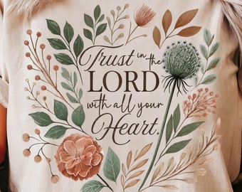 May include: A beige t-shirt with a floral design and the text "Trust in the LORD with all your Heart. Proverbs 3:5"