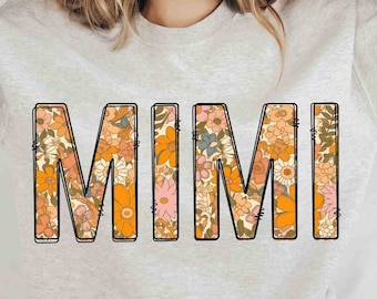 May include: A light gray sweatshirt with the word "MIMI" printed on the front in large, black outlined letters. The letters are filled with a colorful floral pattern in shades of orange, yellow, pink, and blue.