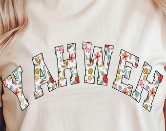 May include: A white t-shirt with a floral design spelling out the word "YAHWEH" in a varsity style font.