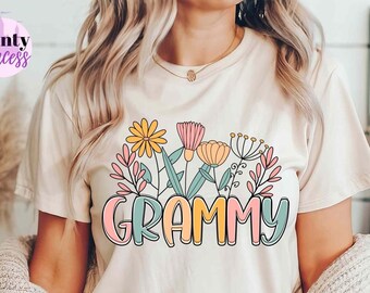 May include: A white t-shirt with a floral design and the word "GRAMMY" in colorful letters.