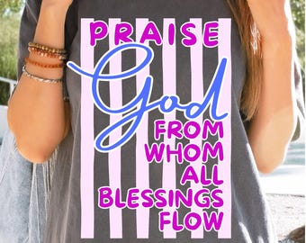 May include: Dark gray t-shirt with the text "PRAISE GOD FROM WHOM ALL BLESSINGS FLOW" in a vertical striped design. The text is in blue and pink, creating a visually appealing contrast.