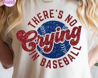 May include: A white t-shirt with a red and blue glitter design that says "There's No Crying In Baseball".