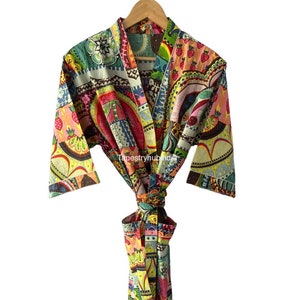 May include: A colorful, patterned robe with a tie belt. The robe features a patchwork design with various fruits, flowers, and geometric shapes. The robe is made of cotton and is available in a variety of sizes.