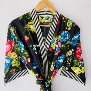 May include: Black floral print robe with white and black striped trim. The robe has a shawl collar and a tie belt. The text "Tapestryhubindia" is visible on the robe.