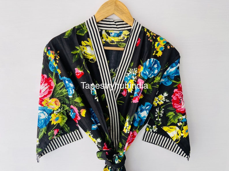 May include: Black floral print robe with white and black striped trim. The robe has a shawl collar and a tie belt. The text "Tapestryhubindia" is visible on the robe.