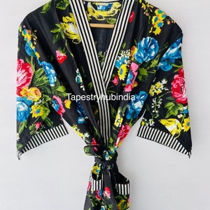 May include: Black floral print robe with white and black striped trim. The robe has a tie belt and a pocket on the left side. The text "Tapestryhubindia" is visible on the robe.