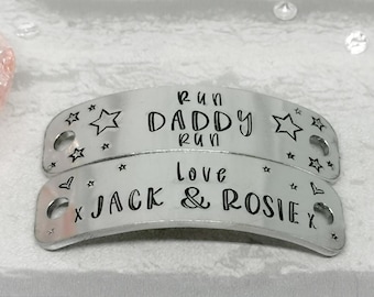 May include: Two silver metal shoe charms with black text. The top charm reads "Run Daddy Run" with a star on each side. The bottom charm reads "Love Jack & Rosie" with a heart and stars on each side.