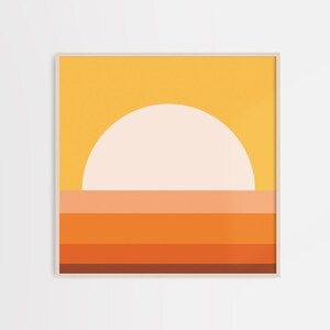 May include: Abstract geometric art print featuring a large white circle representing the sun, set against a yellow background. The bottom of the print features a series of horizontal stripes in shades of orange, red, and brown.