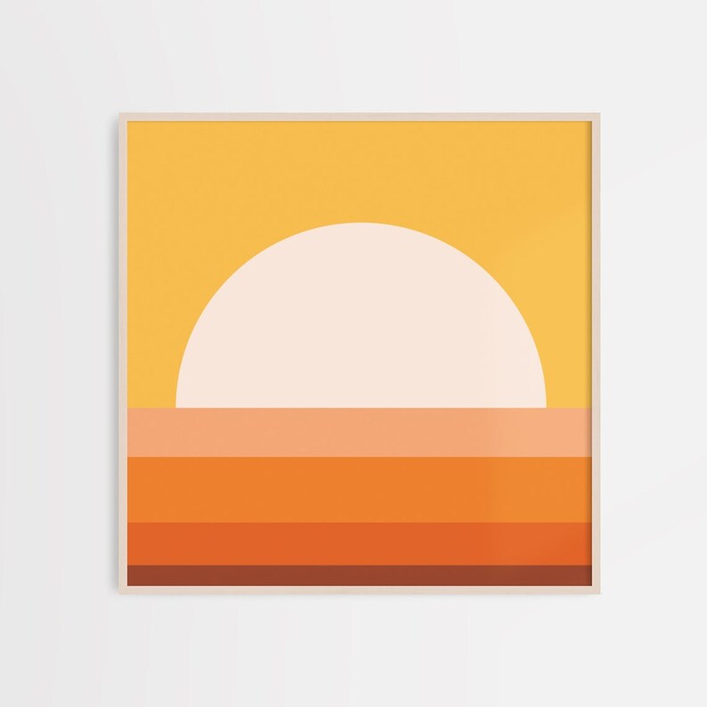 May include: Abstract geometric art print featuring a large white circle representing the sun, set against a yellow background. The bottom of the print features a series of horizontal stripes in shades of orange, red, and brown.