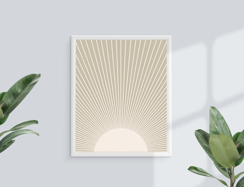 Puede incluir: Una impresi&oacute;n enmarcada con un fondo beige y l&iacute;neas blancas que irradian desde el centro, formando un patr&oacute;n de rayos de sol. El centro del patr&oacute;n de rayos de sol es un c&iacute;rculo blanco.